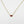 Load image into Gallery viewer, Gold necklace with a red gemstone pendant on a white background