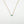 Load image into Gallery viewer, Gold necklace with a blue gemstone pendant on a white background
