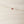 Load image into Gallery viewer, Gold bracelet with a red gemstone on a light wooden surface

